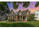 Classic red brick home with symmetrical design, dark shutters, front porch and manicured lawn at sunset at 9251 Palm Bay Cir, Raleigh, NC 27617