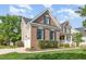 Brick home featuring an attached two-car garage with siding, nicely maintained shrubs, and a sidewalk at 9251 Palm Bay Cir, Raleigh, NC 27617