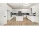 Well lit kitchen with white cabinetry, center island and stainless steel appliances at 9251 Palm Bay Cir, Raleigh, NC 27617