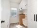 Efficient laundry room with a deep sink, ample storage, and window for natural light at 9251 Palm Bay Cir, Raleigh, NC 27617