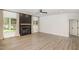 Bright living room featuring wood floors, a cozy fireplace with a wood mantle, and large windows at 9251 Palm Bay Cir, Raleigh, NC 27617