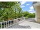 Balcony with white railings and views of the surrounding trees and neighborhood at 1000 Lamond Ave, Durham, NC 27701