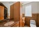 Bathroom showcasing wooden cabinets, neutral walls, and a tiled backsplash at 1000 Lamond Ave, Durham, NC 27701
