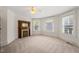 A carpeted bedroom featuring a fireplace and windows at 1000 Lamond Ave, Durham, NC 27701