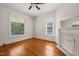 Bedroom with hardwood floors, a ceiling fan, and a decorative fireplace with a mirror at 1000 Lamond Ave, Durham, NC 27701