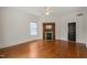 Bedroom featuring hardwood floors, a ceiling fan, and a decorative fireplace with a mirror at 1000 Lamond Ave, Durham, NC 27701