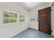 Bedroom with three windows and a painted floor at 1000 Lamond Ave, Durham, NC 27701