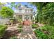 Inviting two-story home with charming curb appeal, lush landscaping, brick pathway and grand entrance with porch at 1000 Lamond Ave, Durham, NC 27701