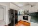 Kitchen with white cabinets, dark green counters, and black appliances at 1000 Lamond Ave, Durham, NC 27701