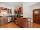 Charming kitchen with wood cabinets, stainless steel appliances, and an island with open shelving at 1000 Lamond Ave, Durham, NC 27701