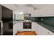 View of kitchen featuring black appliances, white cabinetry and green counters at 1000 Lamond Ave, Durham, NC 27701