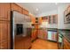 Well-lit kitchen with stainless steel appliances, wood cabinets, and dark countertops at 1000 Lamond Ave, Durham, NC 27701