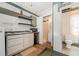 Cozy kitchen featuring modest appliances, white cabinets, and small breakfast bar with shelving at 1000 Lamond Ave, Durham, NC 27701