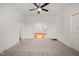 Spacious living room area with neutral carpet, a modern ceiling fan, and bright white trim at 1000 Lamond Ave, Durham, NC 27701