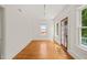 Sun-filled living room featuring hardwood floors, white trim and a door leading to a balcony at 1000 Lamond Ave, Durham, NC 27701