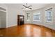 Cozy living room with hardwood floors, a decorative fireplace, and large windows with stained glass accents at 1000 Lamond Ave, Durham, NC 27701