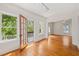Living room with hardwood floors, white trim, and a door leading to a balcony at 1000 Lamond Ave, Durham, NC 27701