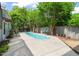 Backyard with an in-ground pool, patio, and mature trees at 1000 Lamond Ave, Durham, NC 27701