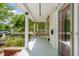 View of the welcoming covered porch featuring a porch swing, white columns, and a view of the front yard at 1000 Lamond Ave, Durham, NC 27701