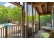 Screened-in porch area with wood floors and views of the pool at 1000 Lamond Ave, Durham, NC 27701
