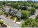 Aerial view of a quaint home on a corner lot, surrounded by lush trees in a peaceful neighborhood at 10003 Fountain, Chapel Hill, NC 27517