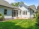 Backyard featuring a well-maintained lawn, a patio, and a view of the home's architecture at 10003 Fountain, Chapel Hill, NC 27517