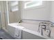 Bathroom featuring shower, tub, window, and tiled flooring at 10003 Fountain, Chapel Hill, NC 27517