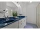 Bright bathroom featuring dual sinks with blue countertop and tiled flooring at 10003 Fountain, Chapel Hill, NC 27517