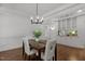 Cozy dining area with hardwood floors, built-in cabinets, and a stylish light fixture at 10003 Fountain, Chapel Hill, NC 27517