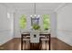 Bright dining room with modern chandelier, hardwood floors, and beautiful trim at 10003 Fountain, Chapel Hill, NC 27517