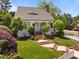 Charming white brick home with a manicured lawn and inviting brick steps to a cozy front porch at 10003 Fountain, Chapel Hill, NC 27517