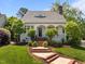 Attractive home featuring a well-maintained front yard and welcoming brick steps leading to the entrance at 10003 Fountain, Chapel Hill, NC 27517