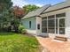 View of the exterior featuring a brick patio, screened in porch and connecting to the backyard at 10003 Fountain, Chapel Hill, NC 27517
