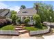 Charming home with a picket fence, landscaped lawn, and brick steps leading to the front door at 10003 Fountain, Chapel Hill, NC 27517