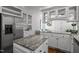 Bright kitchen with granite countertops, stainless steel appliances, and white cabinets at 10003 Fountain, Chapel Hill, NC 27517