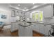 Well-lit kitchen with granite countertops, white cabinets, and stainless steel appliances at 10003 Fountain, Chapel Hill, NC 27517
