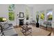 Bright living room with decorative fireplace, large windows, hardwood floors and stylish seating area at 10003 Fountain, Chapel Hill, NC 27517