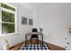 Well-lit home office with a dark desk, natural light, hardwood floors, and view to the outdoors at 10003 Fountain, Chapel Hill, NC 27517