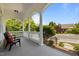 Covered front porch with decorative columns, seating, and views of the landscaped front yard at 10003 Fountain, Chapel Hill, NC 27517
