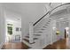 Elegant staircase with white railings and dark wood steps, leading to the upper level of the home at 10003 Fountain, Chapel Hill, NC 27517