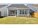 Backyard with a patio, screened in porch, lawn, and newly planted landscaping at 1021 Greatland Rd, Durham, NC 27703
