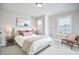 Bedroom with neutral walls, windows with white trim, a modern bed, and carpet at 1021 Greatland Rd, Durham, NC 27703