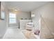Cozy bedroom with neutral walls, chair, area rug, and a tent near the window at 1021 Greatland Rd, Durham, NC 27703