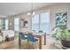 Cozy dining area with natural light, hardwood floors and views into the outdoor living space at 1021 Greatland Rd, Durham, NC 27703