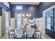 Sophisticated dining room showcasing elegant blue walls, stylish decor, and ample seating around a wooden table at 1021 Greatland Rd, Durham, NC 27703