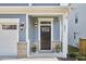 Inviting home entrance with decorative brick accents, black door, and well-maintained landscaping at 1021 Greatland Rd, Durham, NC 27703