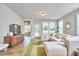 Bright living room features an L-shaped couch, a green rug, a small table and a large tv at 1021 Greatland Rd, Durham, NC 27703