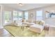 Bright living room features an L-shaped couch, a green rug, and an outside view at 1021 Greatland Rd, Durham, NC 27703