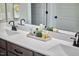 Bright and modern main bathroom features a double vanity with white countertops and black hardware at 1021 Greatland Rd, Durham, NC 27703