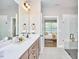 Modern main bathroom features double vanity, large mirror and a glass walk-in shower at 1021 Greatland Rd, Durham, NC 27703